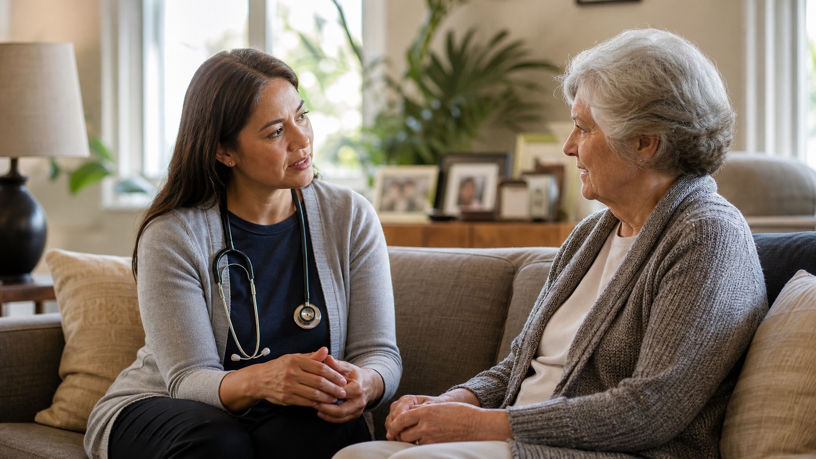 A physician making a house call, talking with a senior patient in her living room